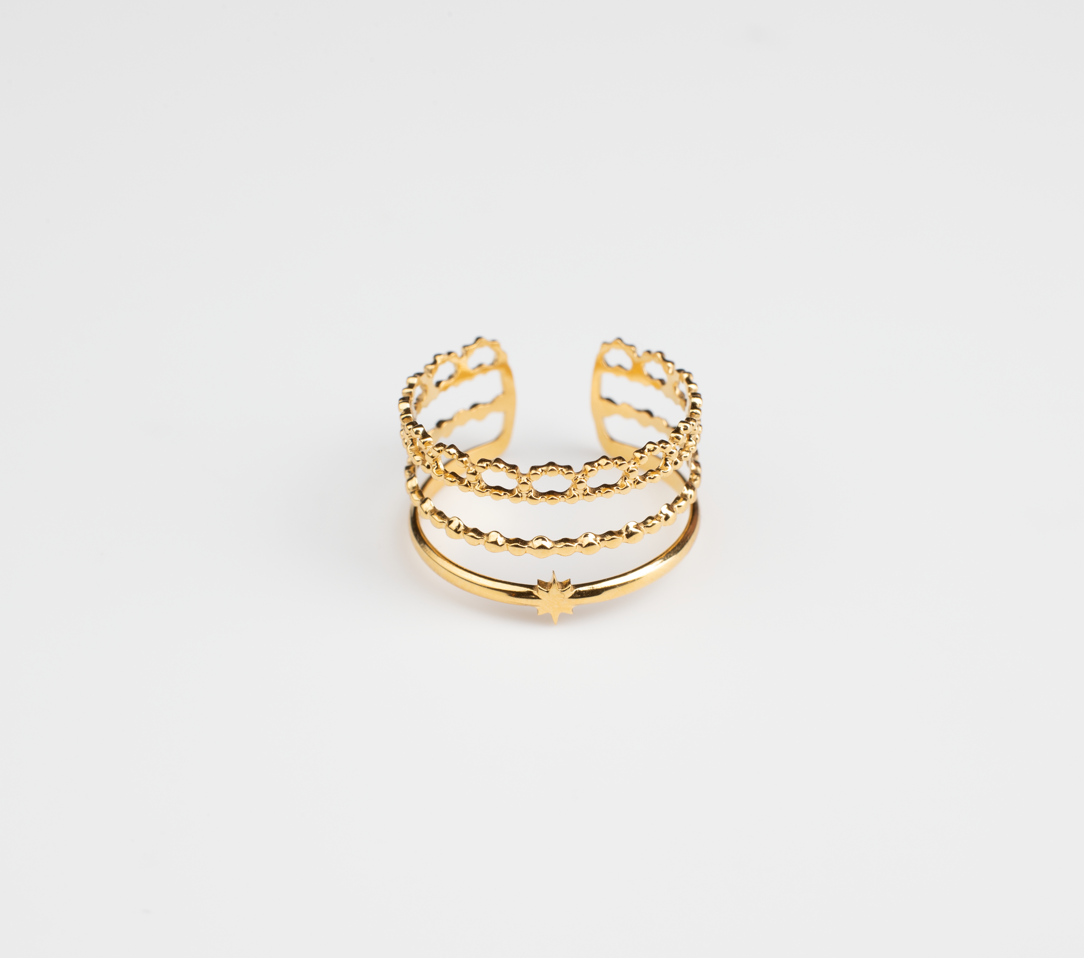 This ring features a three-tiered intricate design, with the outer layer resembling lace-like floral edges. Crafted from titanium steel plated with 18K gold, it exudes a girlish charm, making it playful and adorable. Suitable for everyday wear, the open ring design is adorned with a small star on the band.