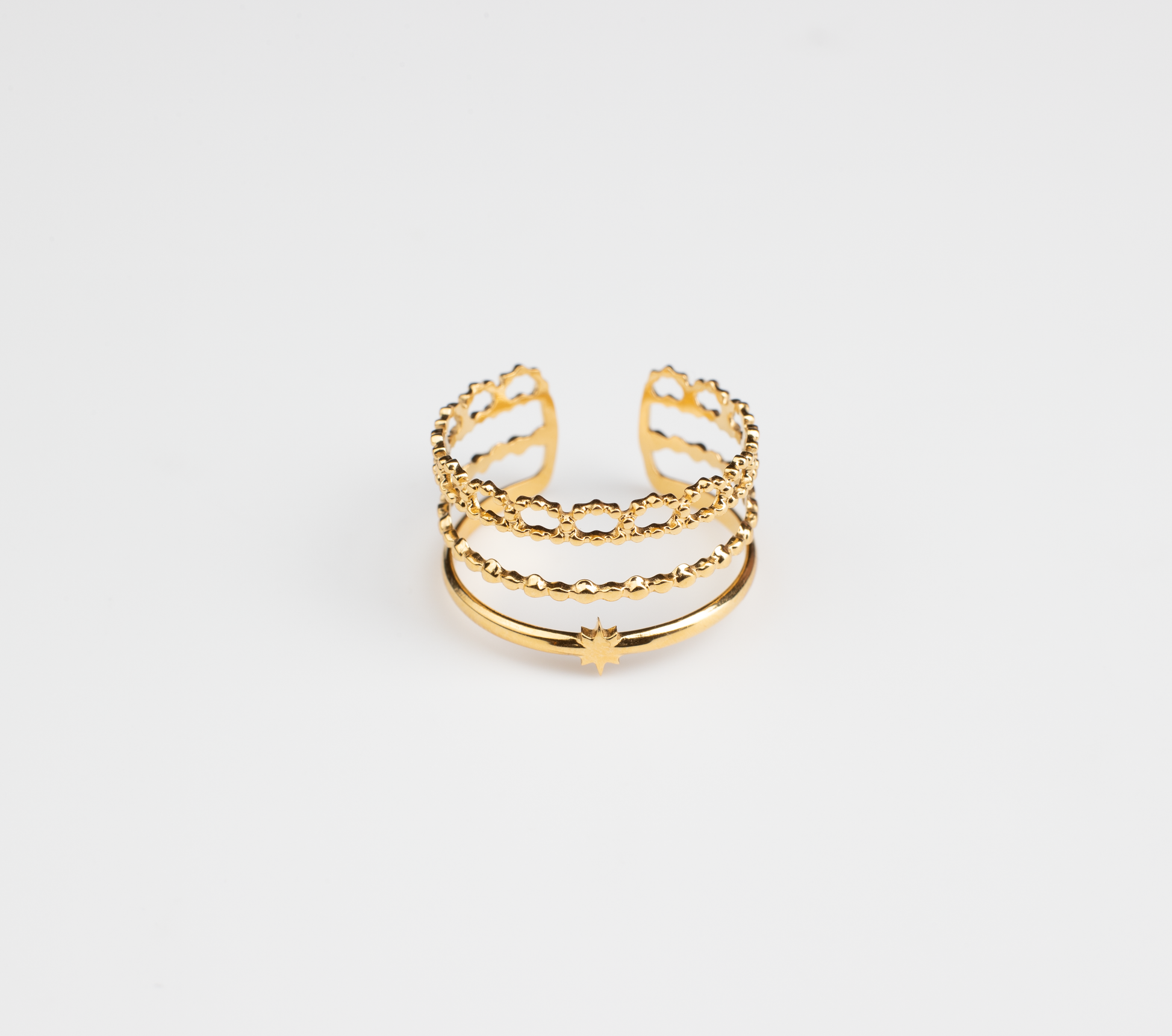 This ring features a three-tiered intricate design, with the outer layer resembling lace-like floral edges. Crafted from titanium steel plated with 18K gold, it exudes a girlish charm, making it playful and adorable. Suitable for everyday wear, the open ring design is adorned with a small star on the band.