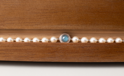 Adjustable in size, our bracelet offers both white and silver pearl options adorned with blue gemstones, exuding elegance and sophistication. Suitable for formal occasions and everyday wear, this women's bracelet makes an elegant gift choice.