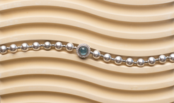 Adjustable in size, our bracelet offers both white and silver pearl options adorned with blue gemstones, exuding elegance and sophistication. Suitable for formal occasions and everyday wear, this women's bracelet makes an elegant gift choice.