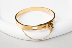 Our gold bracelet, plated with titanium steel and 18K gold, features a clasp closure and adjustable fit, making it both stylish and versatile. Perfect for work and everyday wear, this unisex bangle is a cool and elegant gift option.