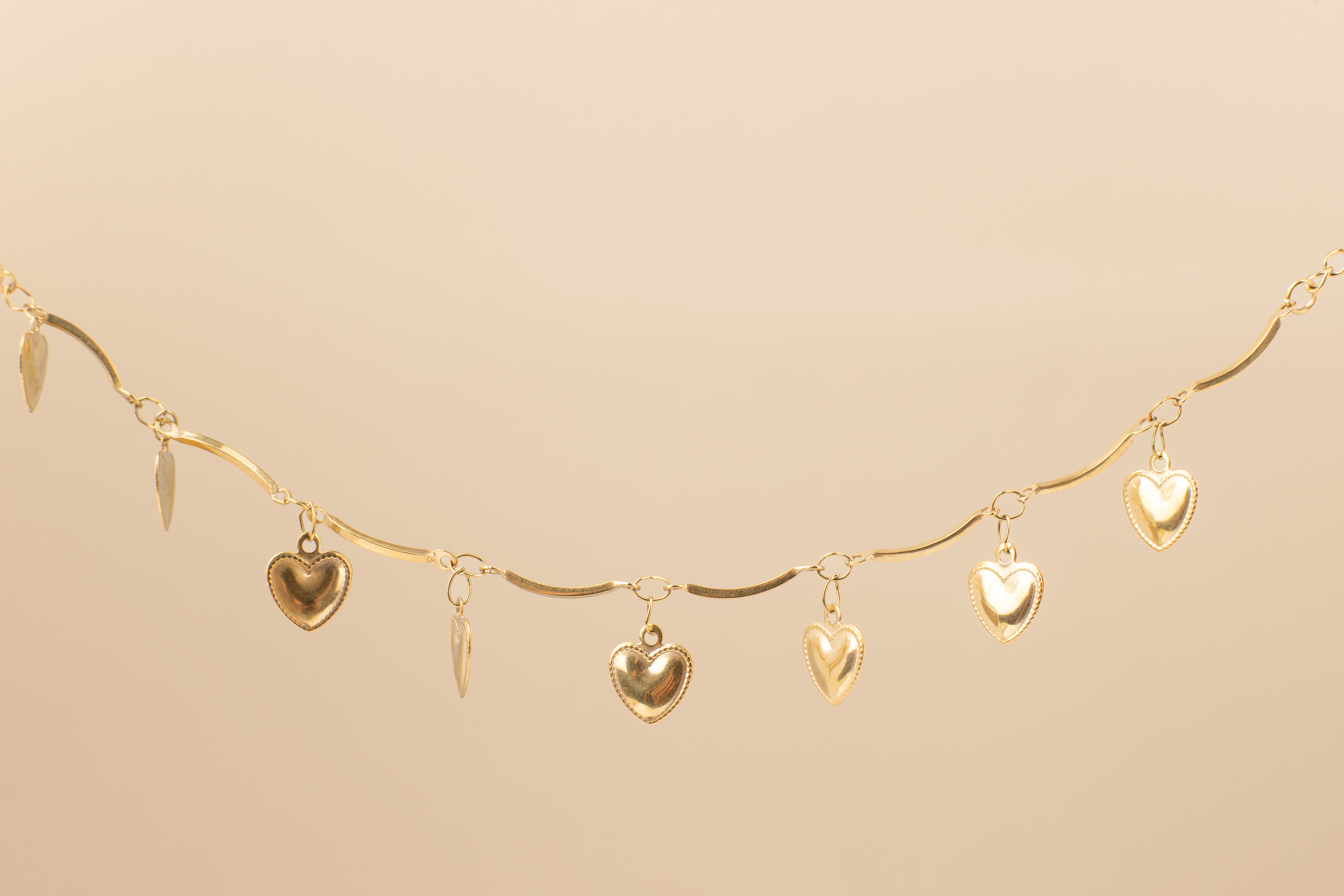 Shine in style with our adorable gold anklet adorned with charming heart pendants, exuding a youthful and playful vibe. Crafted with precision and plated in 18K gold, this anklet is the perfect accessory for beach vacations and leisurely strolls. A delightful gift choice for her.