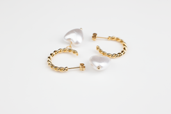 Enhance your elegance with these chic gold earrings adorned with white heart-shaped pearls, perfect for women of all occasions. Crafted from titanium steel plated with 18K gold, they're versatile for formal affairs or leisurely outings. An ideal gift selection for someone special.