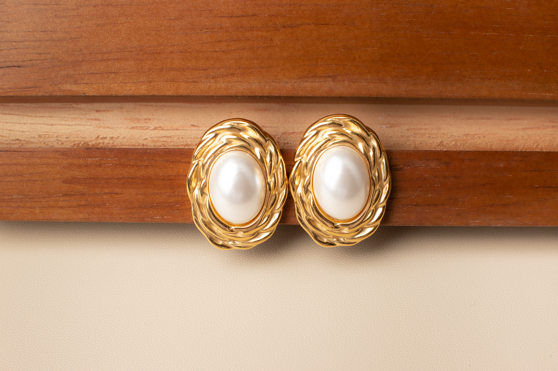 Discover timeless elegance with our classic pearl earrings. Featuring white pearls framed by delicate gold accents, these earrings exude sophistication and grace. Perfect for formal occasions, professional settings, or evening events, they effortlessly complement any attire, adding a touch of maturity and refinement. Ideal for women seeking refined accessories or as a thoughtful gift for someone special.