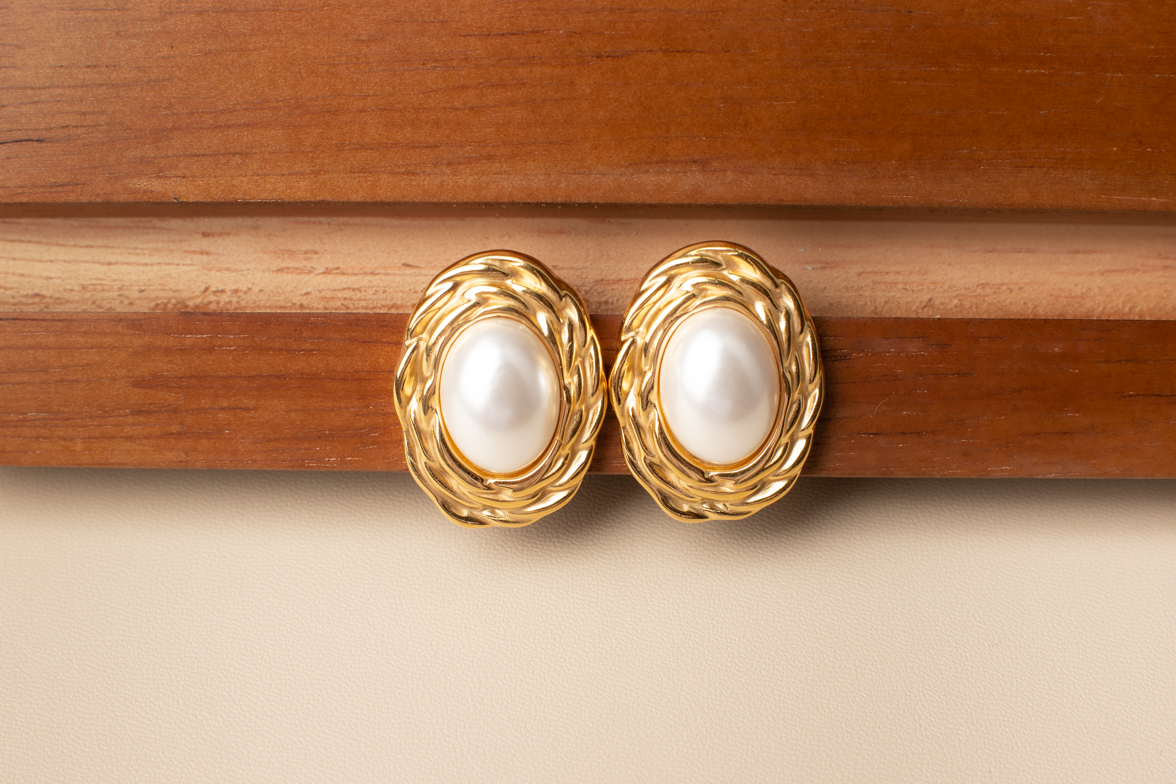 Discover timeless elegance with our classic pearl earrings. Featuring white pearls framed by delicate gold accents, these earrings exude sophistication and grace. Perfect for formal occasions, professional settings, or evening events, they effortlessly complement any attire, adding a touch of maturity and refinement. Ideal for women seeking refined accessories or as a thoughtful gift for someone special.