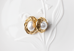 Discover timeless elegance with our classic pearl earrings. Featuring white pearls framed by delicate gold accents, these earrings exude sophistication and grace. Perfect for formal occasions, professional settings, or evening events, they effortlessly complement any attire, adding a touch of maturity and refinement. Ideal for women seeking refined accessories or as a thoughtful gift for someone special.