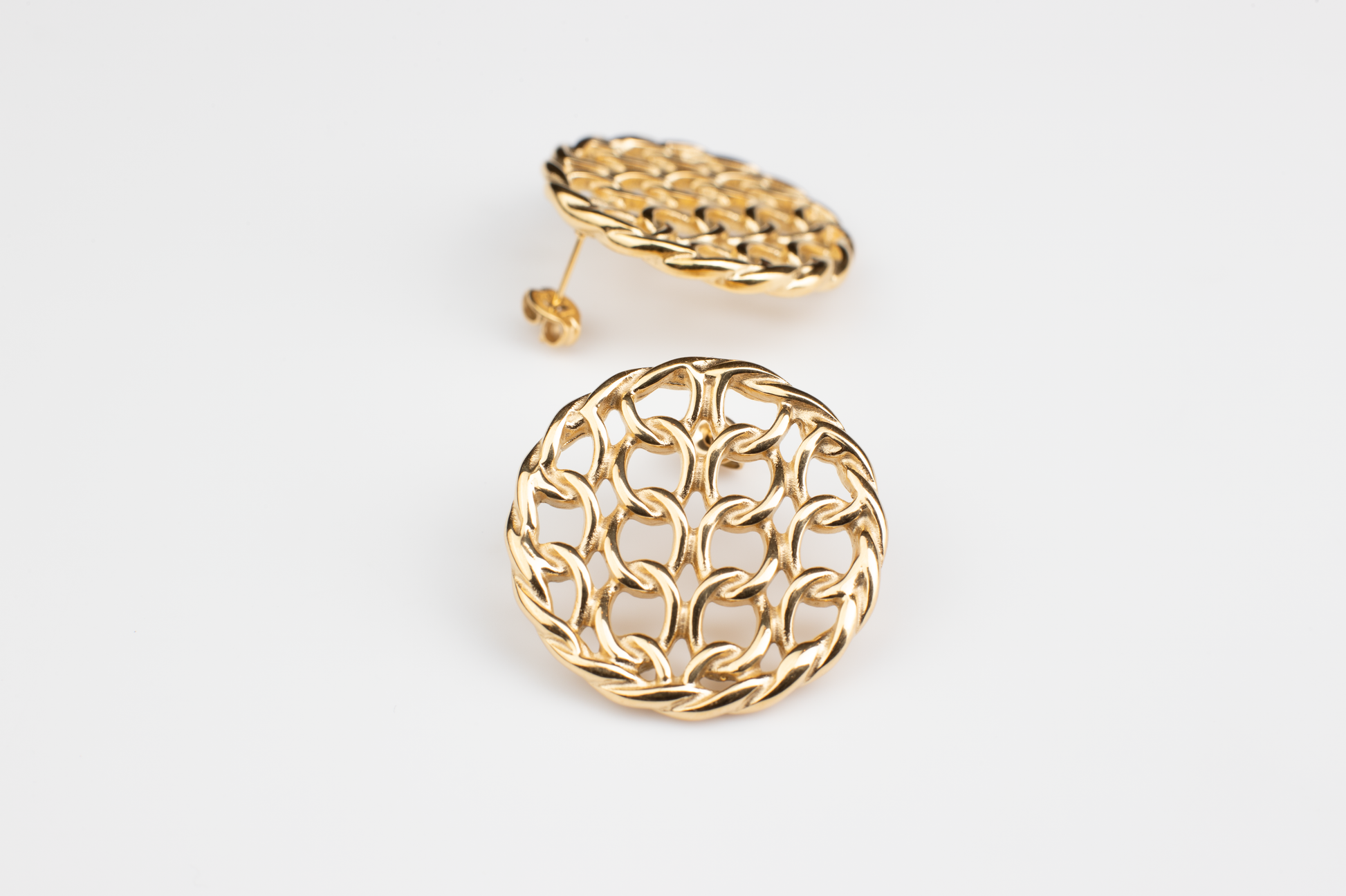 Adorn your ears with sophistication and style with our golden circular mesh hollow earrings. Crafted from titanium steel plated with 18K gold, these elegant and fashionable accessories are versatile, perfect for any occasion. Personalize your look with these exquisite earrings, designed specifically for women who appreciate timeless beauty and individuality. An ideal gift choice for those who appreciate refined elegance.