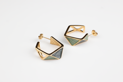 Embrace the avant-garde with our geometrically inspired earrings. Featuring multi-faceted designs, intricate hollow patterns, and vibrant green hues accented by golden borders, these earrings exude elegance and modernity. Plus, with the option for ear clips, they're versatile for any occasion. Crafted with titanium steel plated in 18K gold, they make a perfect gift.