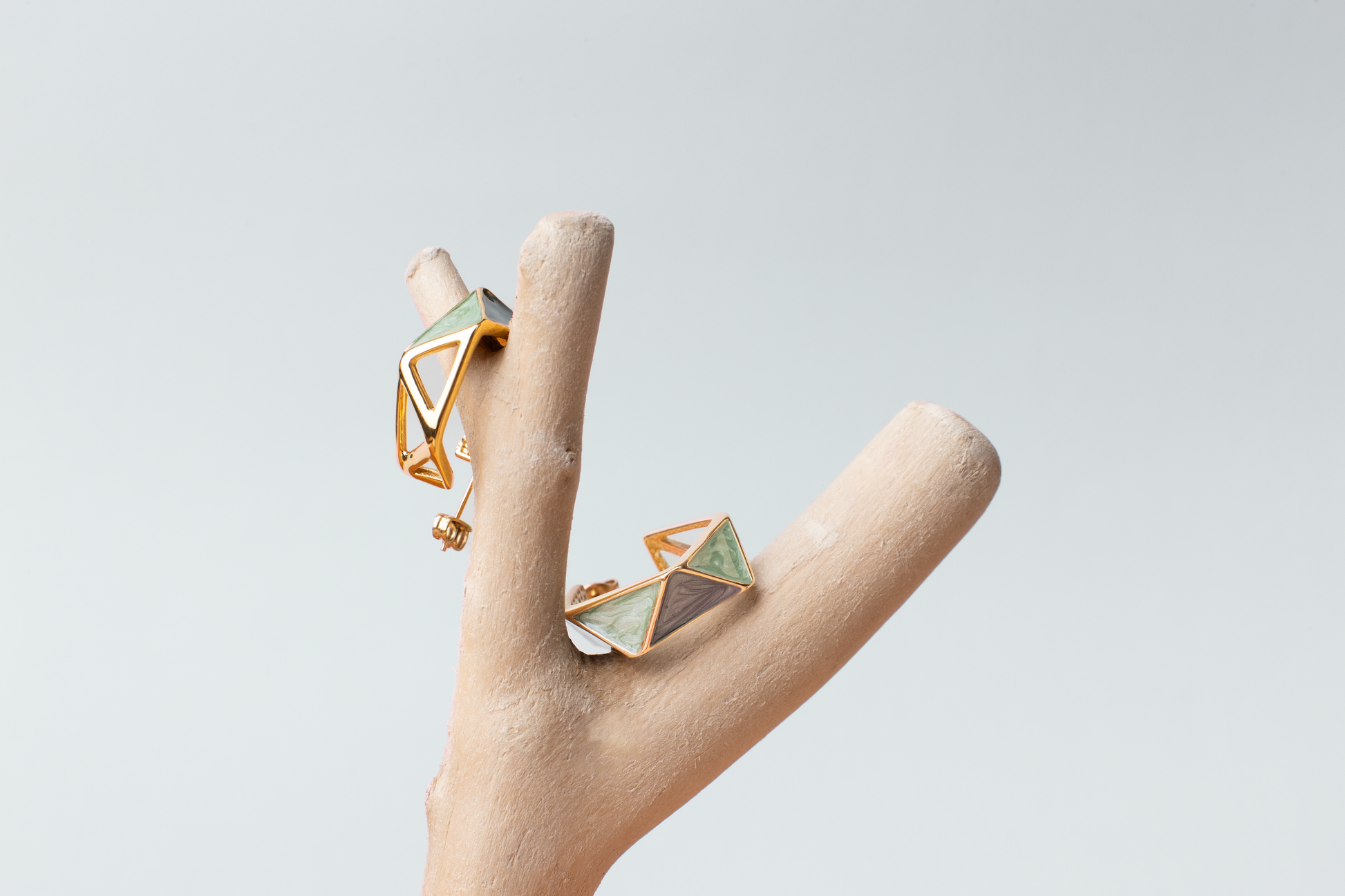 Embrace the avant-garde with our geometrically inspired earrings. Featuring multi-faceted designs, intricate hollow patterns, and vibrant green hues accented by golden borders, these earrings exude elegance and modernity. Plus, with the option for ear clips, they're versatile for any occasion. Crafted with titanium steel plated in 18K gold, they make a perfect gift.