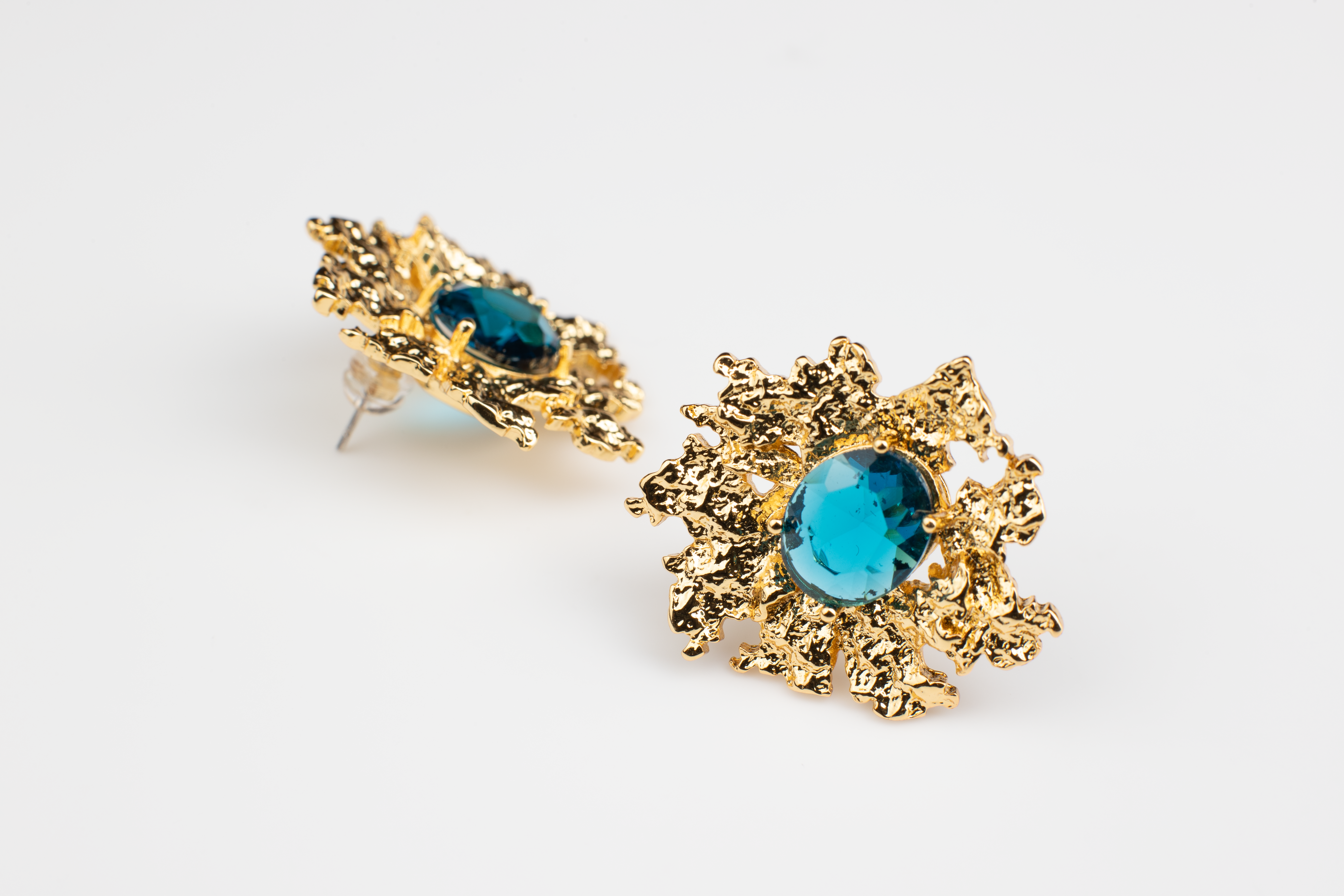 Exquisite, attention-grabbing earrings featuring stunning blue gemstones set in titanium steel plated with 18K gold. Ear clips available for added versatility. Perfect for various occasions and as a thoughtful gift.