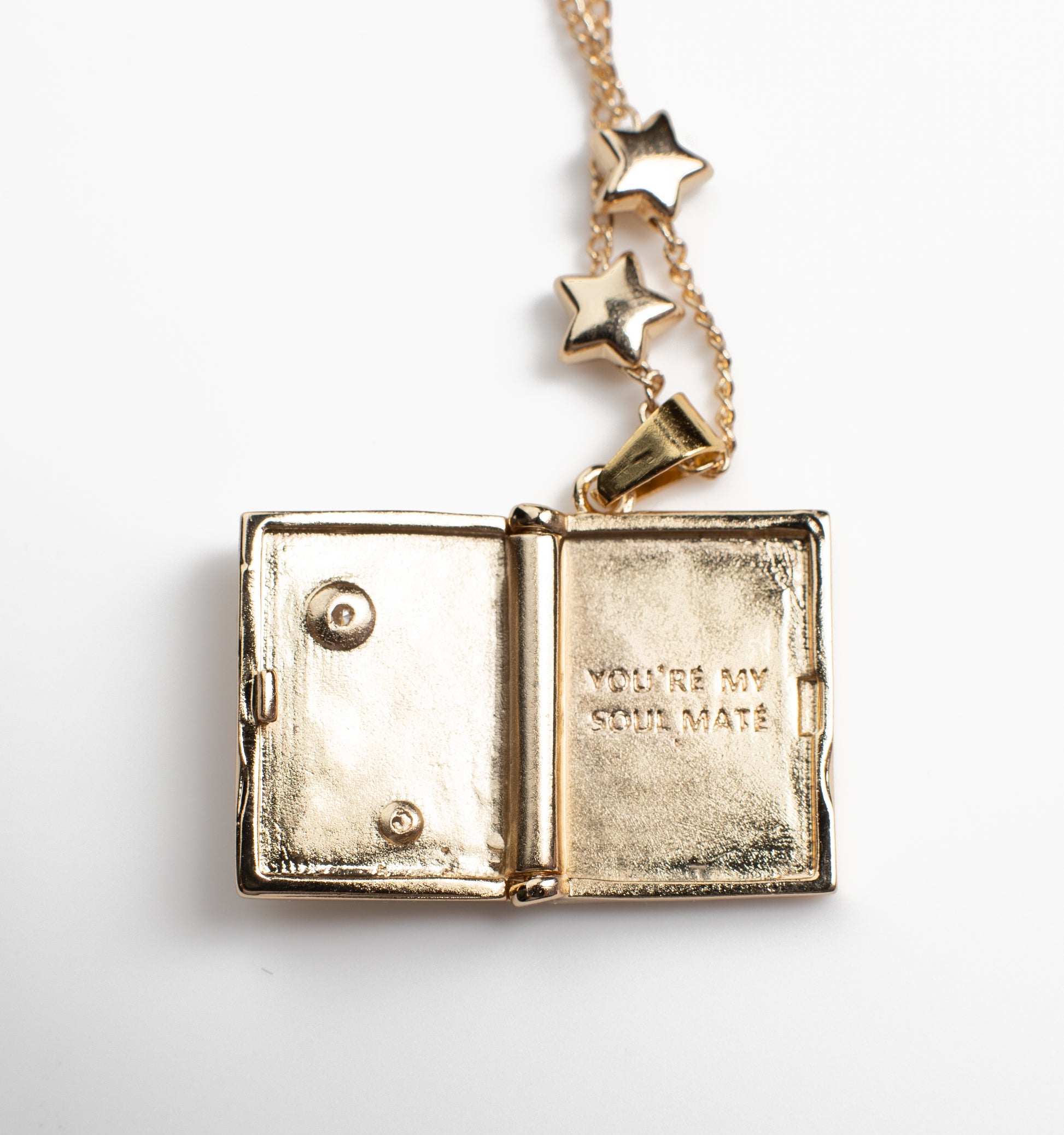 Open book-shaped locket necklace with a celestial design, crafted from copper with 14K gold plating. The interior features an engraving that reads "YOU'RE MY SOUL MATE," adding a romantic and personal touch. Displayed on a clean white background, highlighting its intricate details and meaningful design.